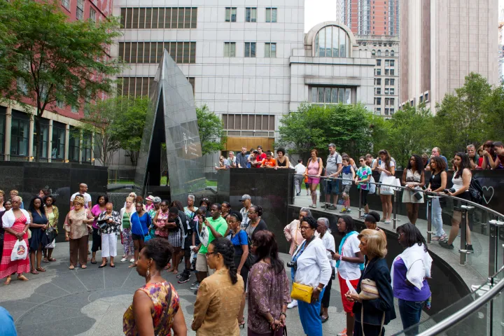 a group of people walking down the street in front of a crowd