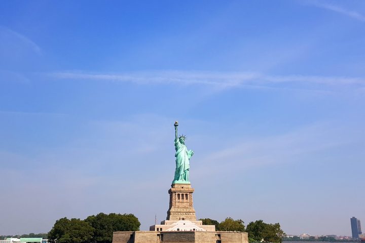 a large clock tower next to a body of water