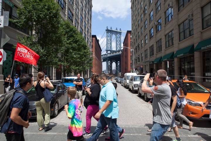 a group of people walking on a city street